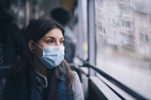 Worried Woman With Protective Face Mask In Bus Transport.