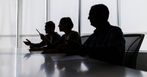 Silhouette of business people negotiating at meeting table