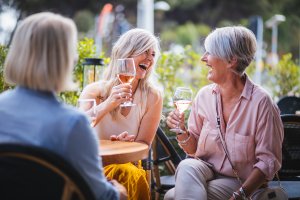 Happy senior women drinking wine